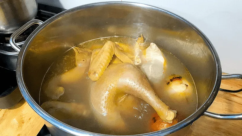 Luộc ức gà với lửa vừa và hớt bọt thường xuyên giúp nước dùng súp trong và ngọt thanh.